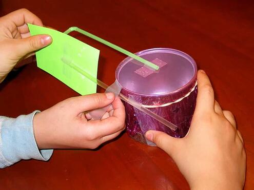 taping straight straw with post-it note to the can