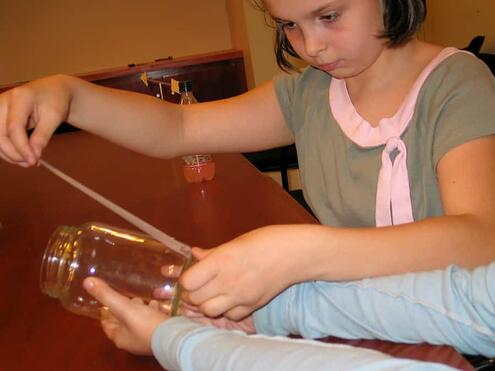 applying a line of tape up the side of glass jar