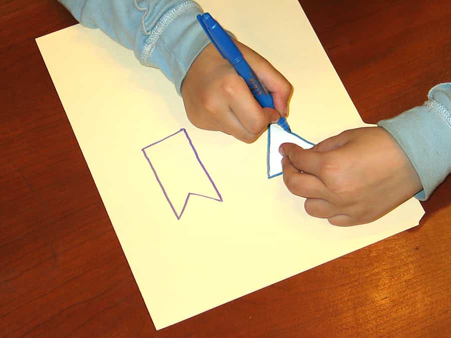 outlining arrow and tail cutout shapes onto cardstock