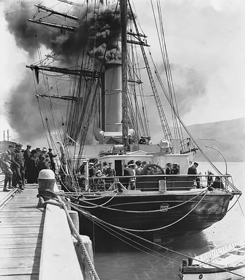 the boat at the dock with crew members