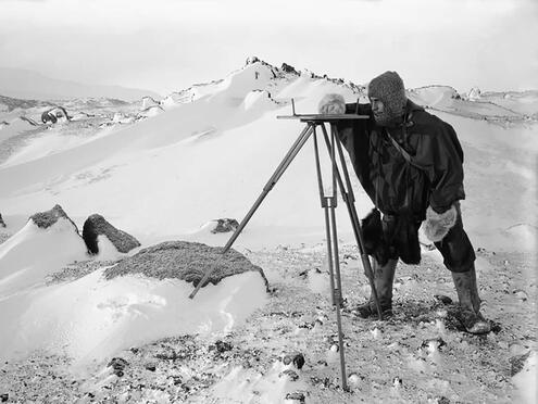 crew member surveying Antarctic landscape