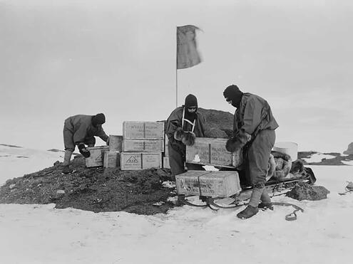 crew placing crates of supplies at outdoor depot