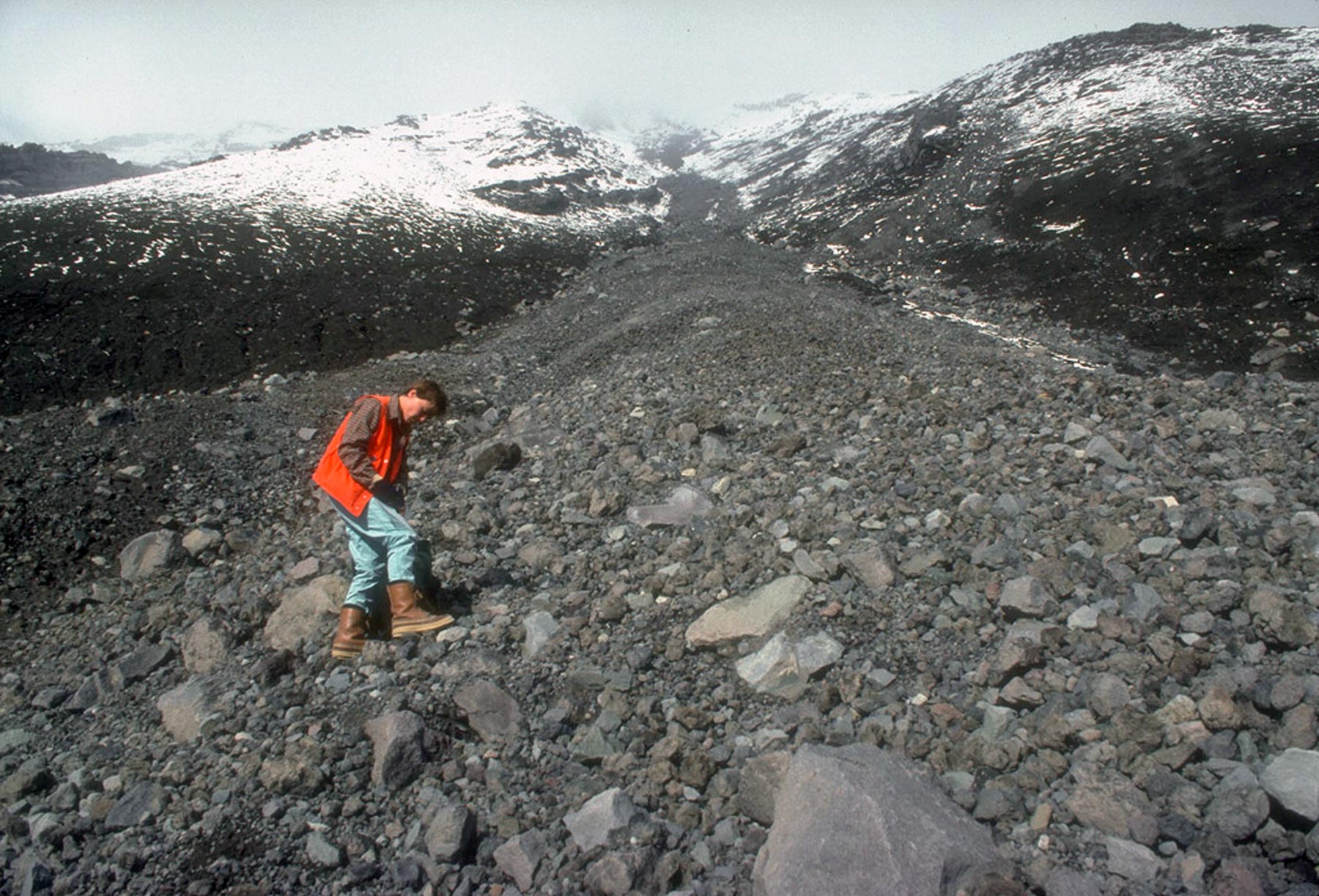 Scientist exploring volcanic mountainside.