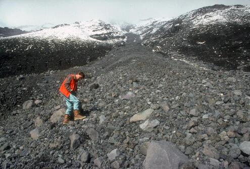 Scientist exploring volcanic mountainside.