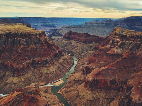 Sweeping view of Grand canyon with river running through.