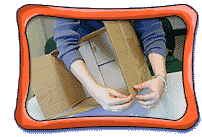 Person, with only their arms visible, holds a cardboard box and handles one lid piece of the box.
