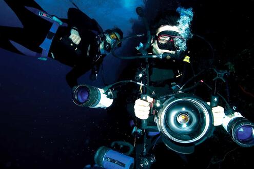 two scientists with underwater camera