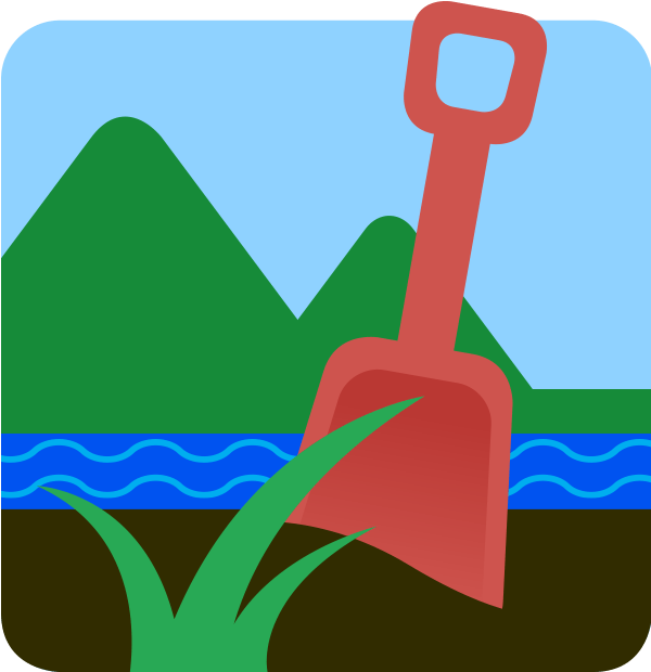 A plastic shovel in dark, rich soil with a stream and mountains in the background.