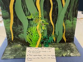 diorama of leafy sea dragon camouflaging in the sea graas