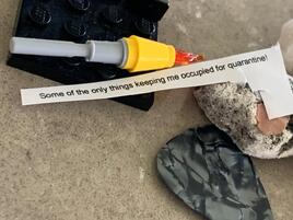 Lego pieces, rocks, and a guitar pick 