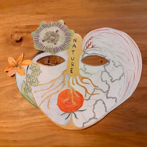 hand drawn mask with flowers and roots and the word nature along length of the nose