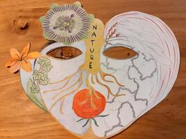 hand drawn mask with flowers and roots and the word nature along length of the nose