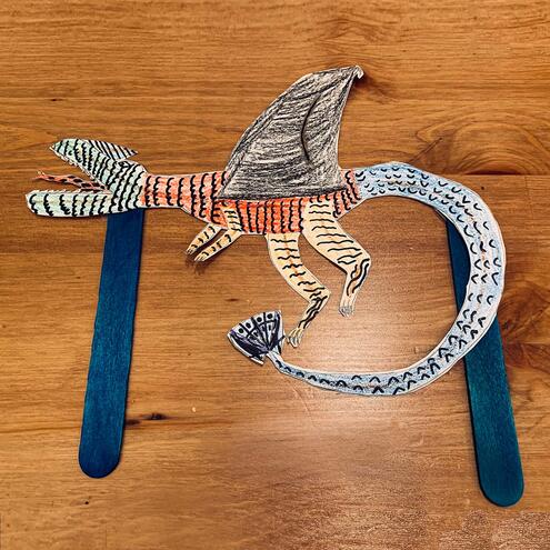 illustrated striped dragon puppet on 2 sticks