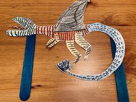 illustrated striped dragon puppet on 2 sticks