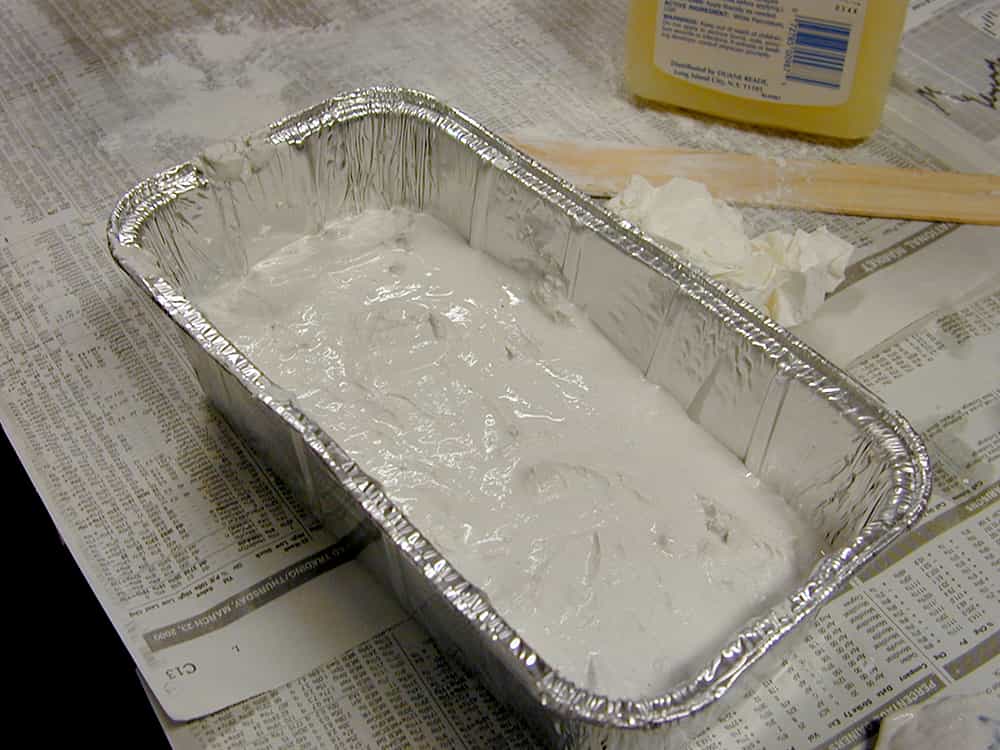 plaster-covered bones sitting in the container