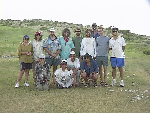 most of the team posing in the grass