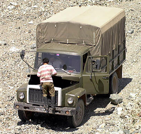 Temir opening hood of the truck to inspect