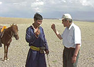Dash displaying hand sign greeting to a nomad man