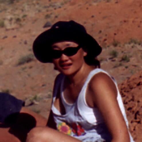 Minjin Bolorsetseg sitting on red rocks in the Gobi