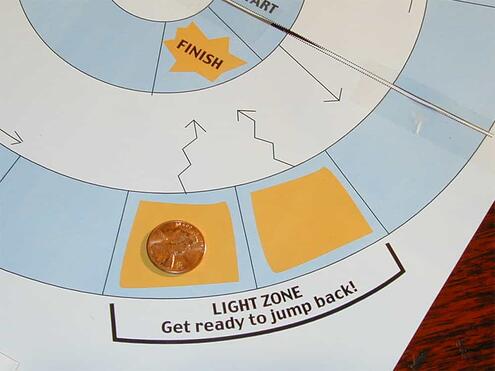 one of the player's markers in the light zone on the board