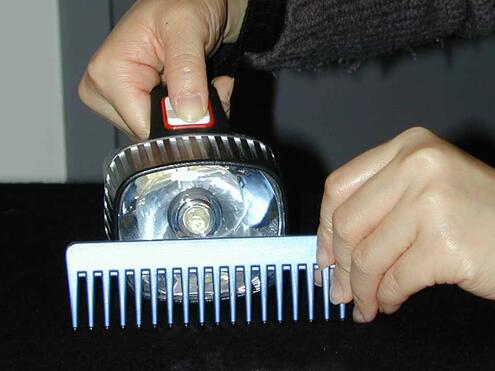 a flashlight with a comb placed in front