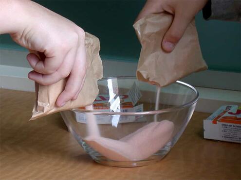 pouring packs of Jell-O powder into a bowl
