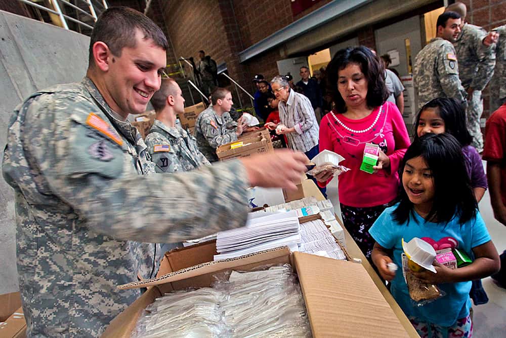 Troops handing out supplies to the community.