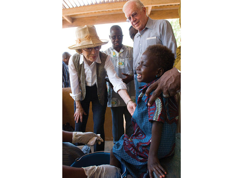 President Jimmy Carter and Rosalynn Carter with a guinea worm patient, Rafia Fusseini, in treatment.