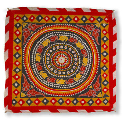 A patterned textile piece with a circular, patterned center inside of a square with a border of alternating colored squares.