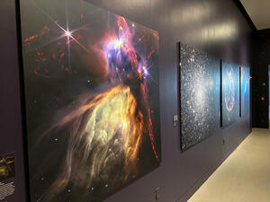 Large photos on the wall with colorful, clear images of space.