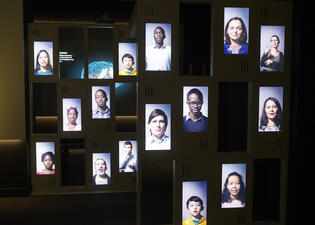 A panel arranged in a collage displays the faces of a variety of different people. 