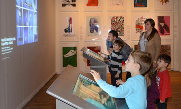 Visitors use a touchscreen monitor to project artwork on the wall