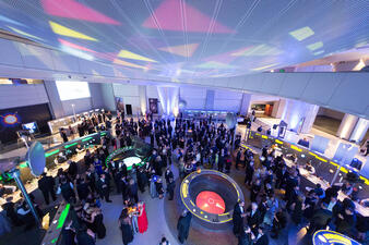 Standing visitors fill the Cullman Hall of the Universe.