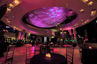 Candlelit tables are set inside the Cullman Hall of the Universe.
