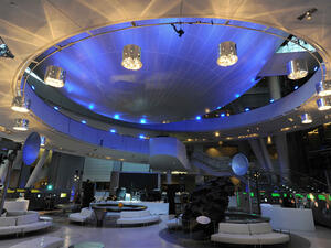 Circular couches surround the displays inside the dramatically-lit Cullman Hall of the Universe.