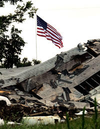 American flag flying over building destroyed in Hurricane Katrina, 2005