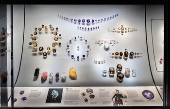Different-colored quartz gems arranged in groups inside a glass display case in the Museum's Halls of Gems and Minerals.