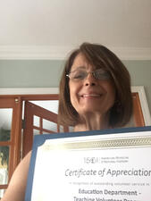 Christina Fagin holds her certificate of appreciation.
