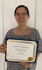 Ellen Hwang holds her certificate of appreciation.