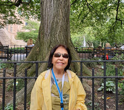 Helena Maria Lim sits on a bench outside the 77th street entrance to the Museum.
