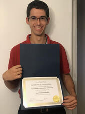 Jean-Baptiste Mollet holds his certificate of appreciation