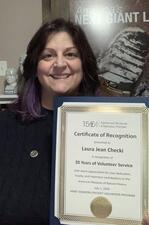 Laura Jean Checki holds her volunteer certificate.
