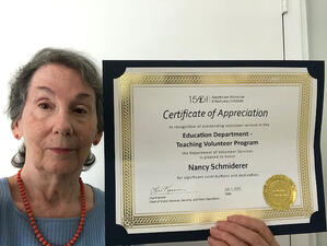 Nancy Schmiderer holds her certificate of appreciation.