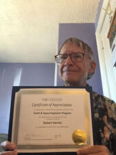 Robert Demko holds his certificate of appreciation.