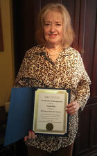 Trudy Reitz holds her certificate of appreciation.