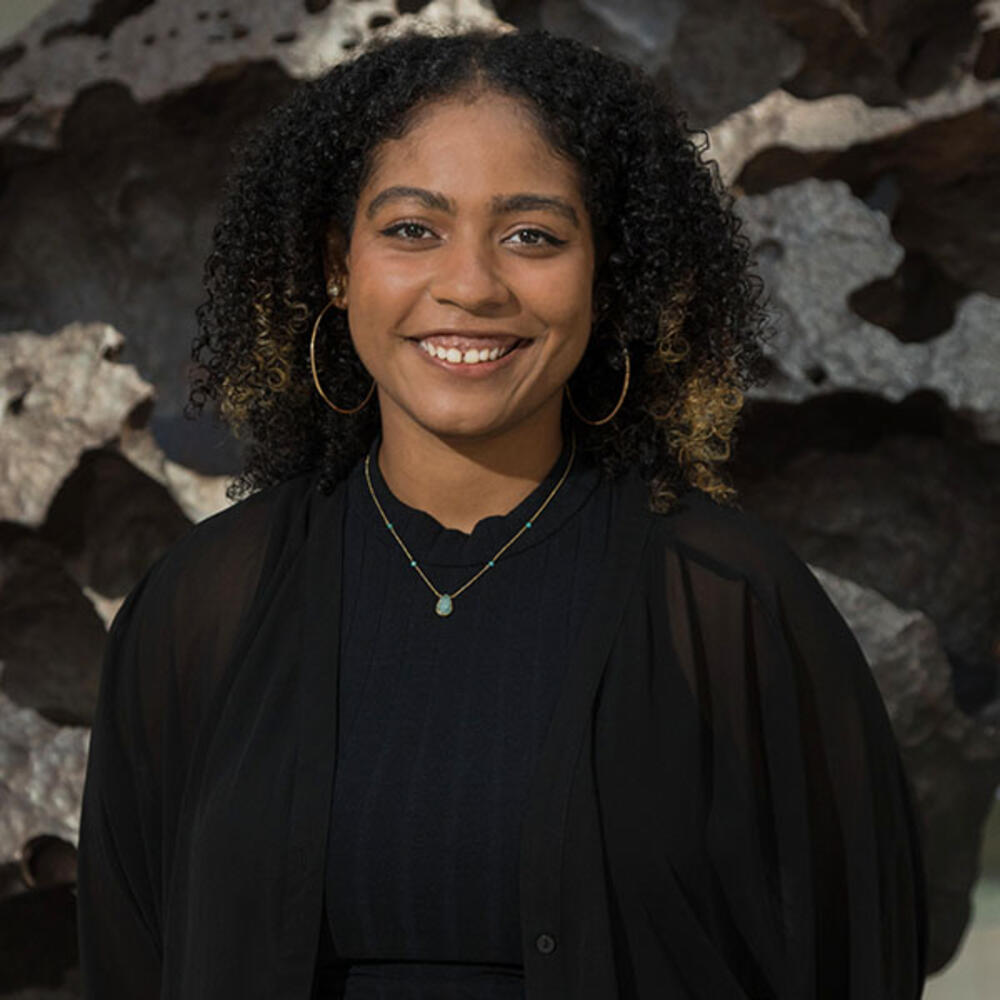 Stivaly Paulino stands for a smiling portrait.