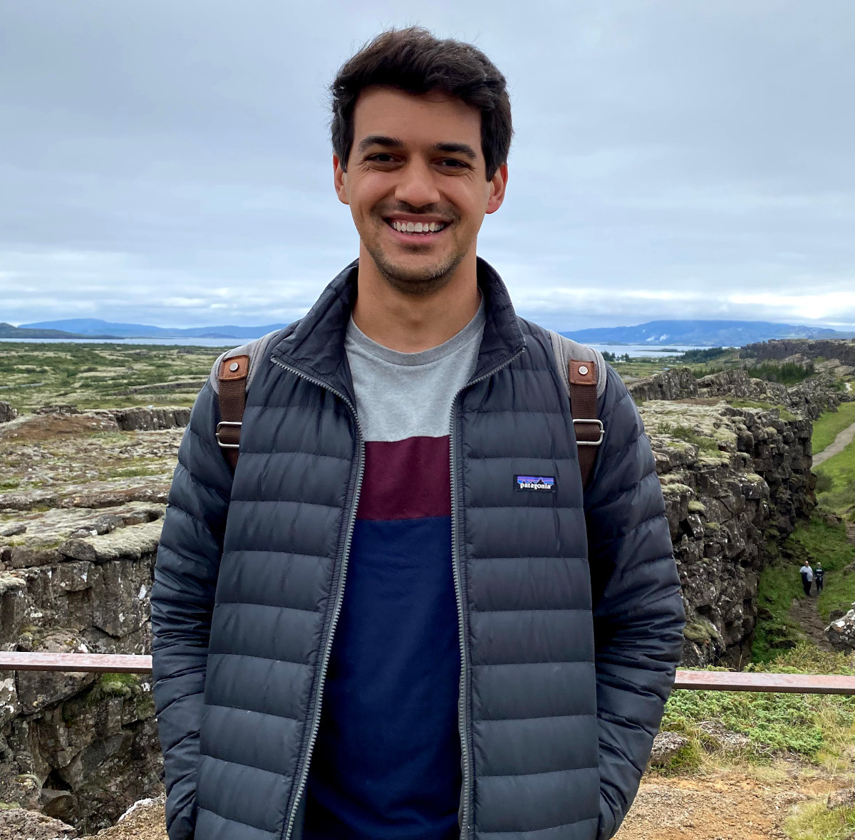 photo of Daniel O'Shoney standing outside near a railing overlooking a mountain and gulley
