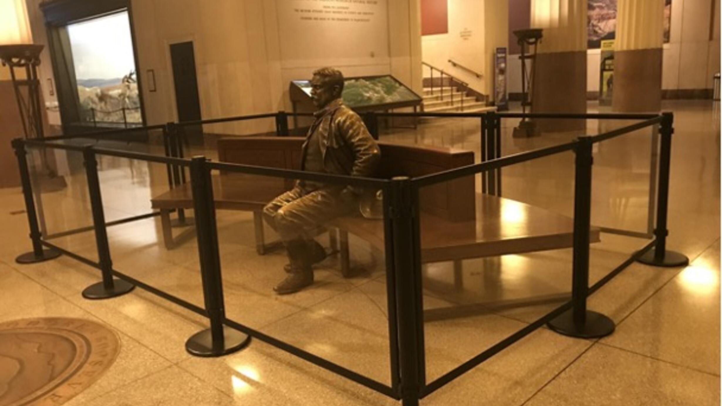 Theodore Roosevelt statue at the American Museum of Natural History behind plexiglass