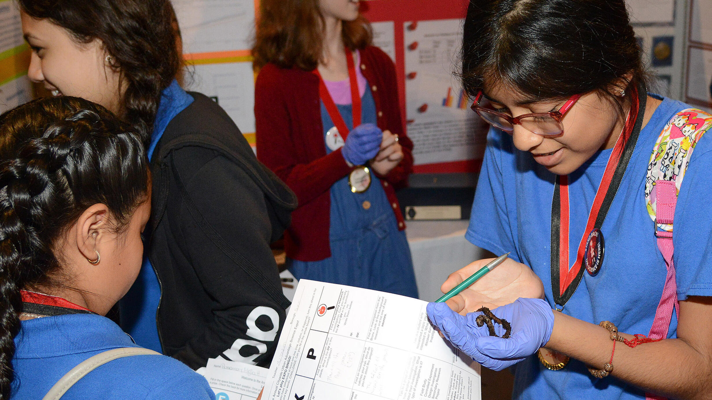 Urban Advantage student displaying worm from their study at expo.