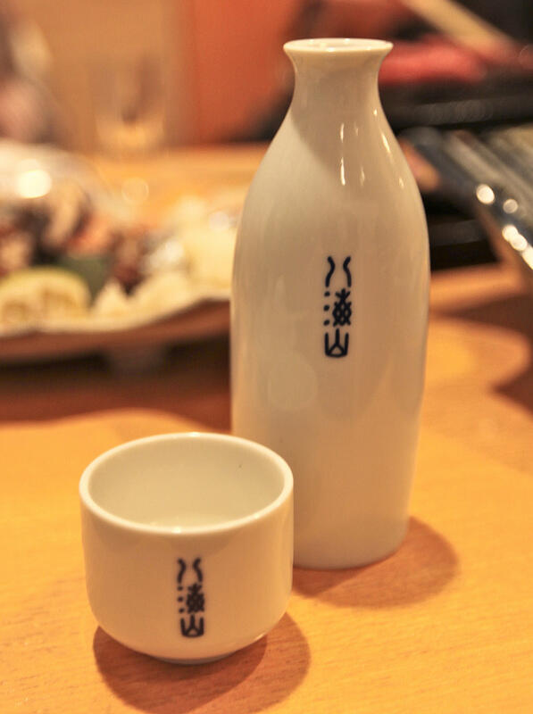Matching white porcelain sake pitcher and cup